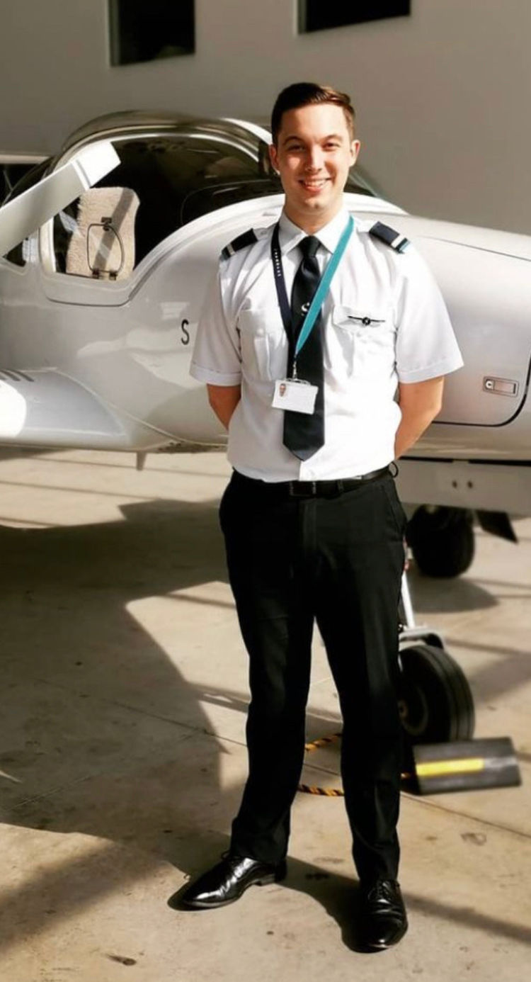 Nick in front of skyborne training plane