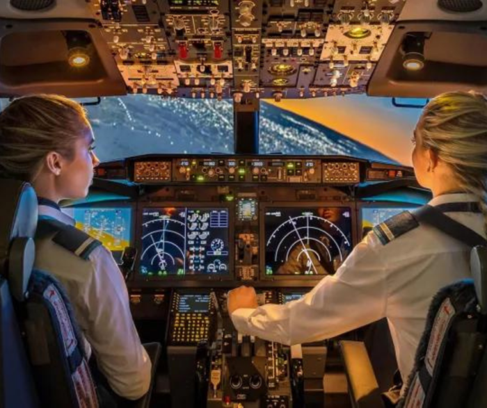 Female pilots in cockpit of a plane