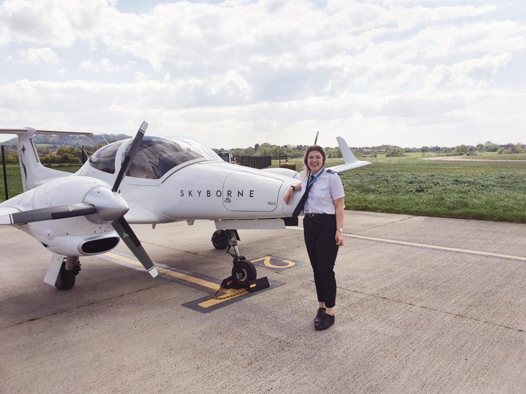 Katherine Miller in front of a training plane